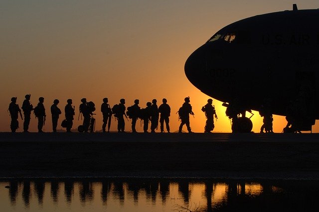 U.S. Army soldiers with airplane at sunset